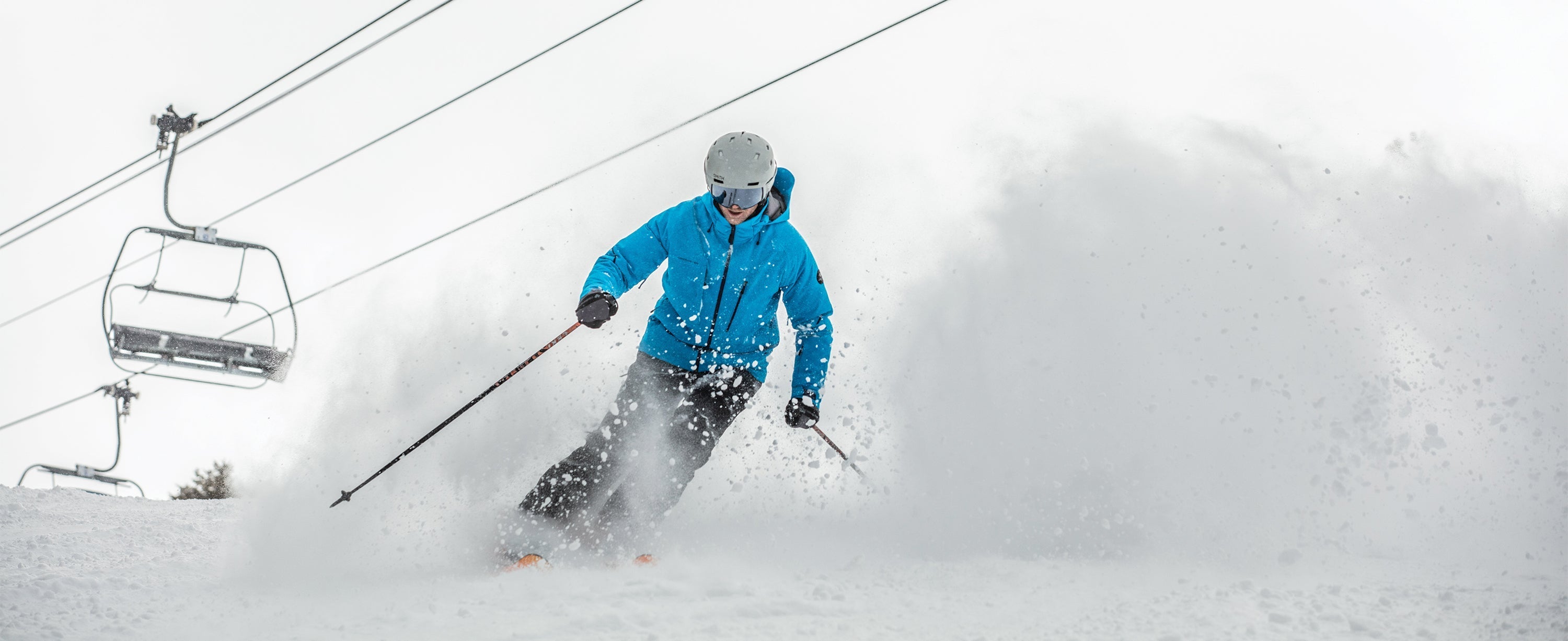 Male skier wearing an Obermeyer ski insulated jacket.