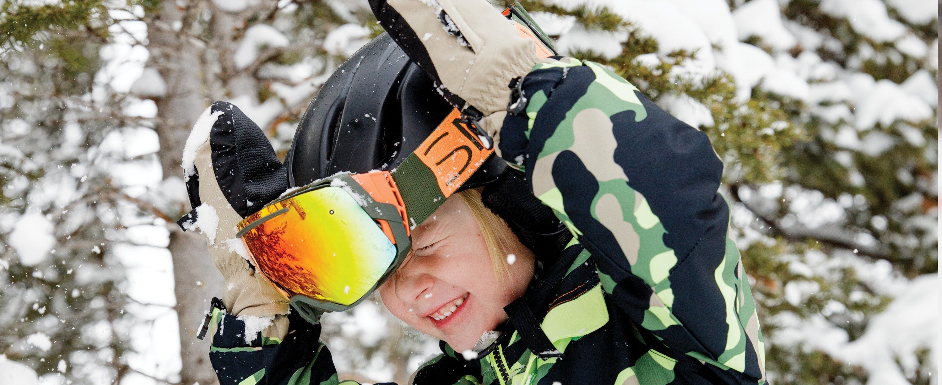 Kid boy wearing Obermeyer gloves.