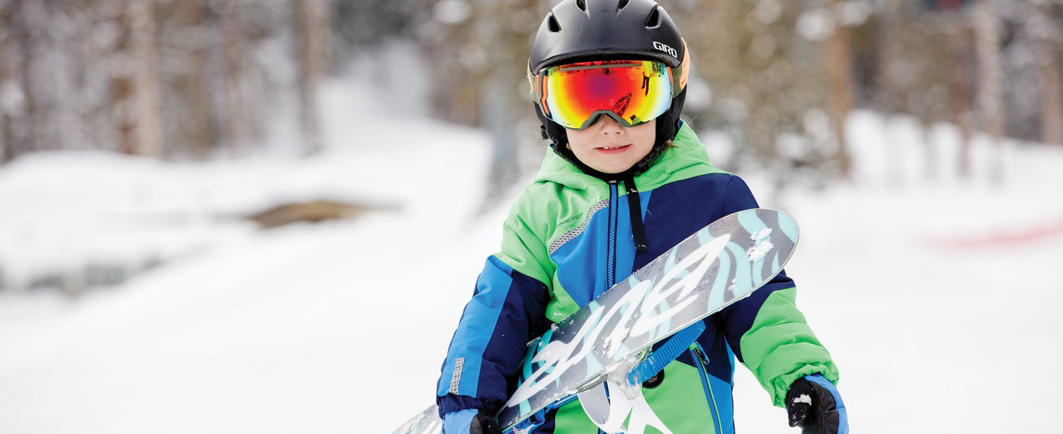 Girl pushing a boy in a sled. Both are wearing Obermeyer ski and snowboard apparel.