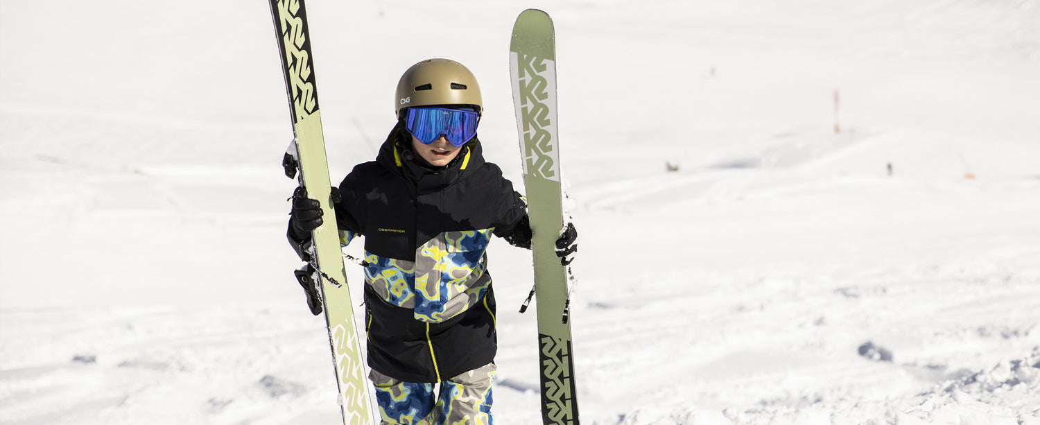Two teen boys skiers wearing Obermeyer ski wear.