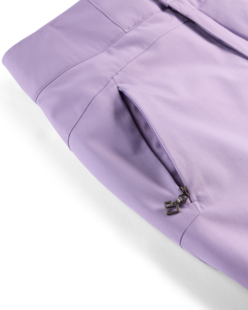 
Close-up of lavender pants showing a side zippered pocket with a dark metal zipper pull on a white background.