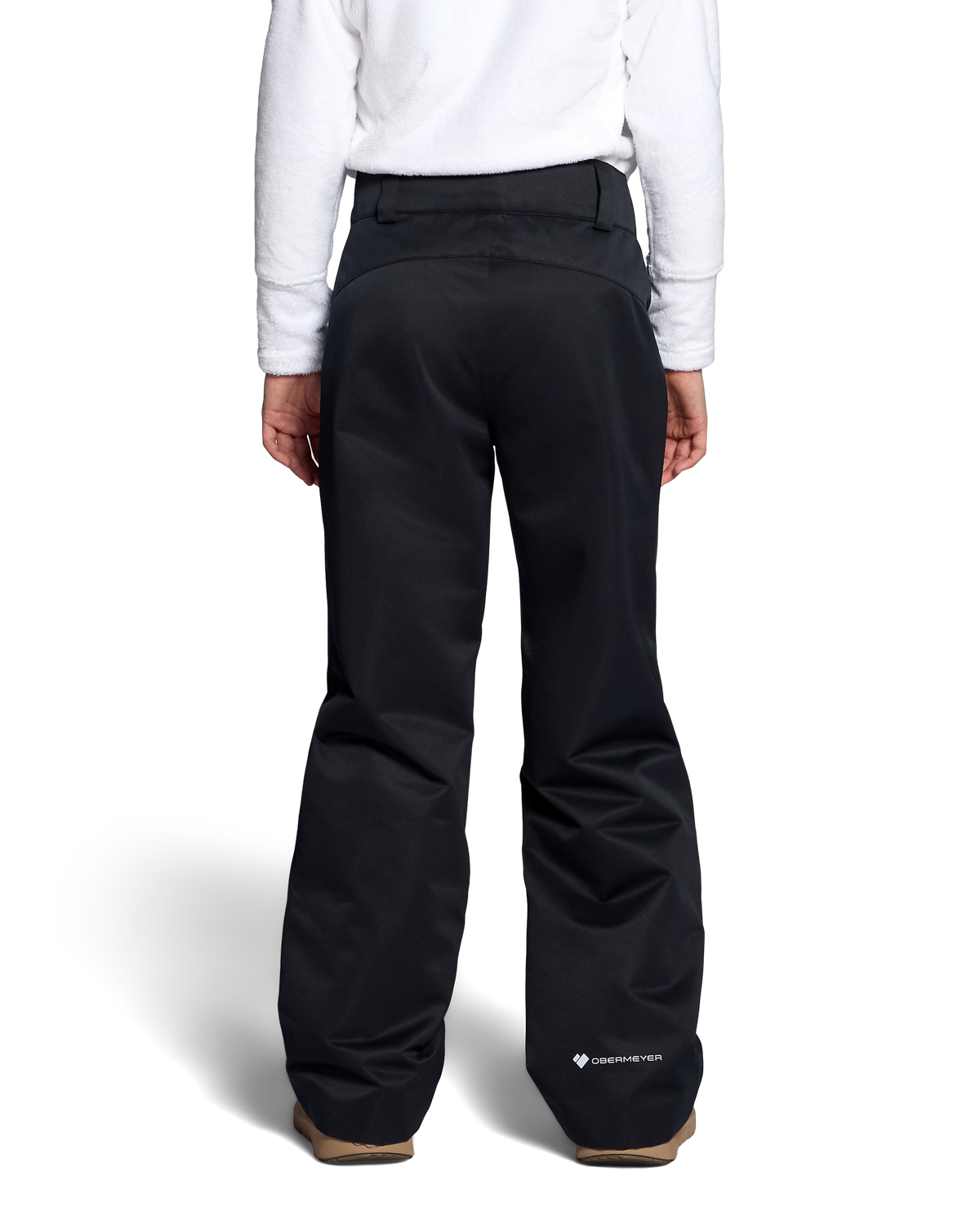 
Rear view of a person wearing black snow pants and a white sweatshirt, standing against a light gray studio background.