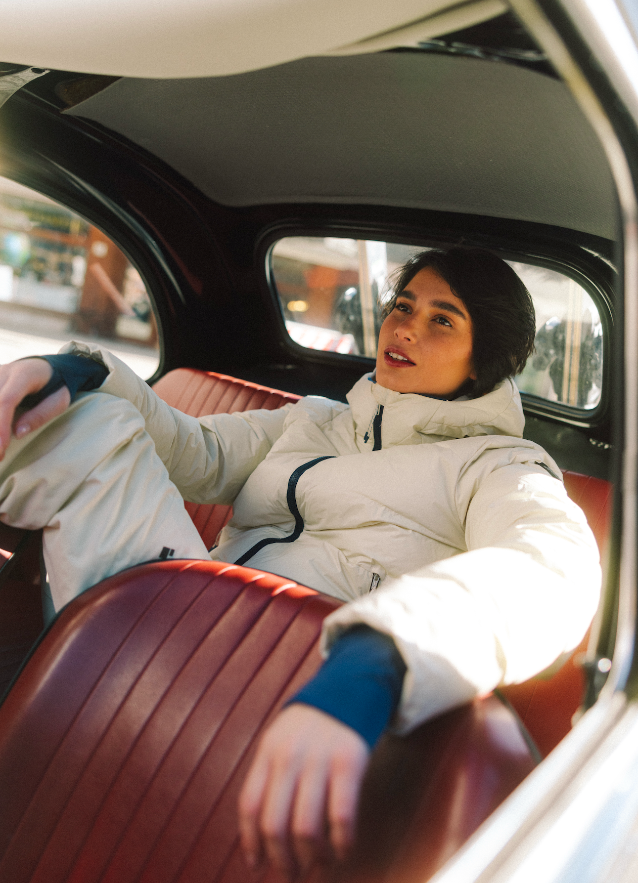 Person sitting inside a car with a focus on the interior.